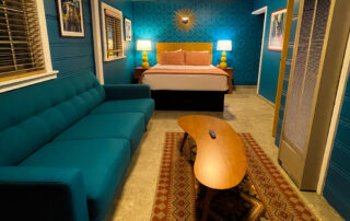 Teal-blue cabin room with connecting lounge, perfect for your stay at Big Bear Hotel.