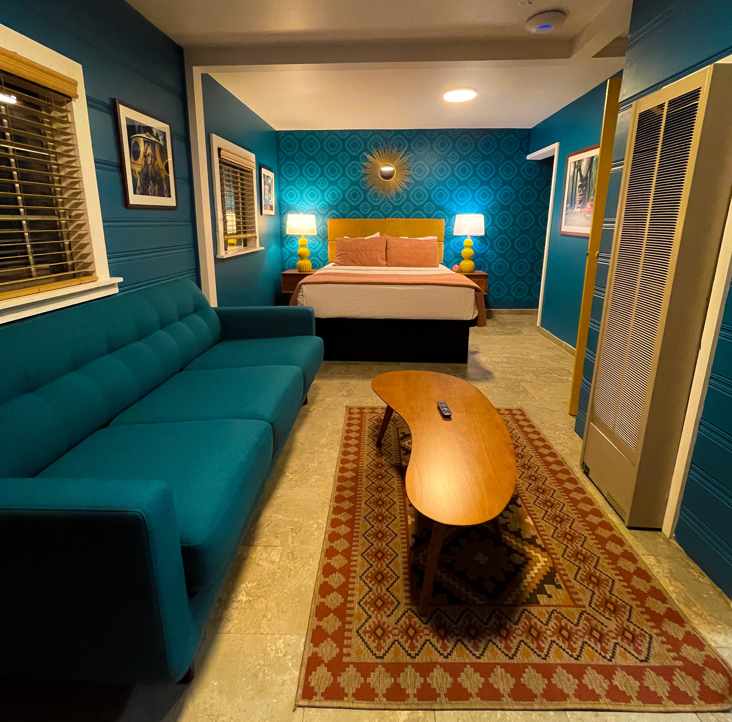 Teal-blue cabin room with connecting lounge, perfect for your stay at Big Bear Hotel.