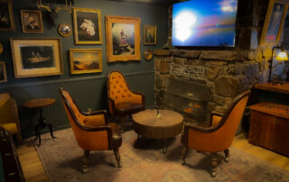 Cozy Vintage Decor at Big Bear Hotel: Couch, Firepit, TV.