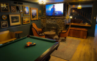 Firepit Lounge with Couch, TV, Decor, and Pool Table at Big Bear Lake Resort