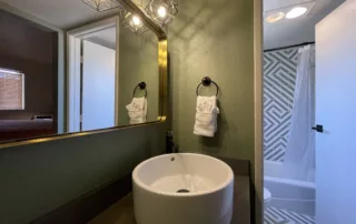 Contemporary Big Bear Hotel Bathroom - Modern Sink, Vanity, and Geometrical Industrial Lighting