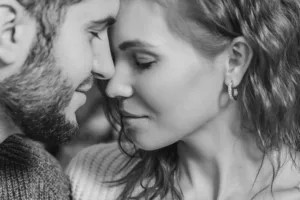 Close-up of a smiling couple sharing an intimate moment at Sessions Retreat, surrounded by natural light and serene beauty.
