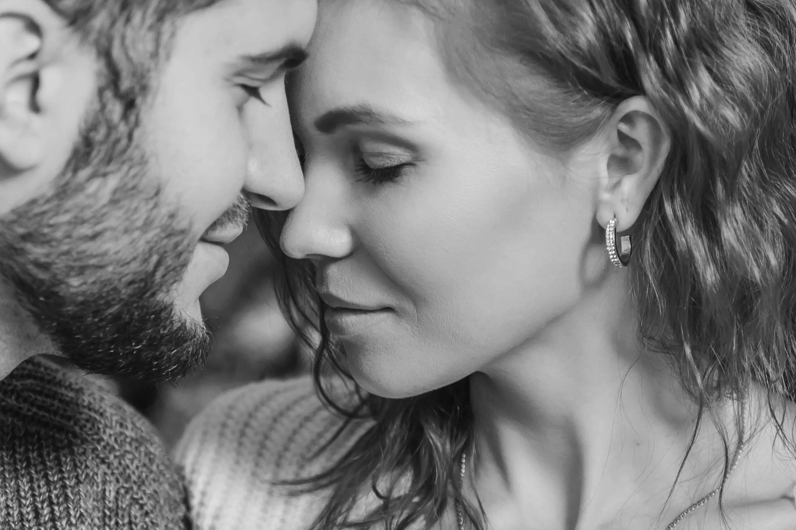 Close-up of a smiling couple sharing an intimate moment at Sessions Retreat, surrounded by natural light and serene beauty.